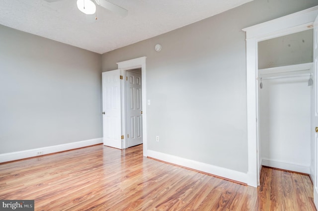 unfurnished bedroom with a closet, light hardwood / wood-style floors, a textured ceiling, and ceiling fan