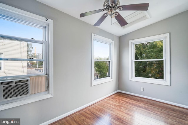 empty room with vaulted ceiling, wood-type flooring, and ceiling fan