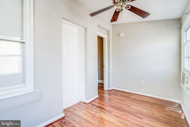 spare room featuring light hardwood / wood-style floors, a healthy amount of sunlight, and ceiling fan