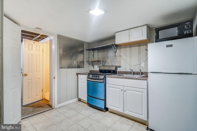 kitchen featuring white fridge, range, white cabinetry, and sink