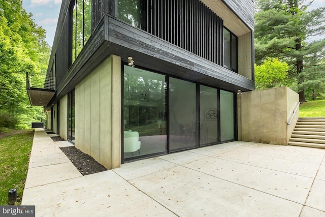 view of side of home featuring a patio area