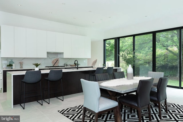 dining room with light tile patterned flooring and sink