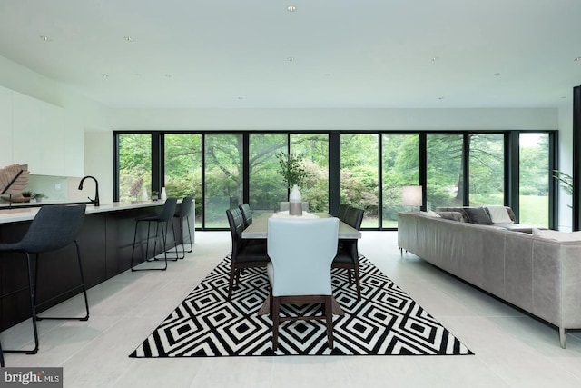 interior space featuring sink, light tile patterned floors, and a wealth of natural light