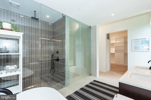 bathroom with vanity, independent shower and bath, and hardwood / wood-style floors