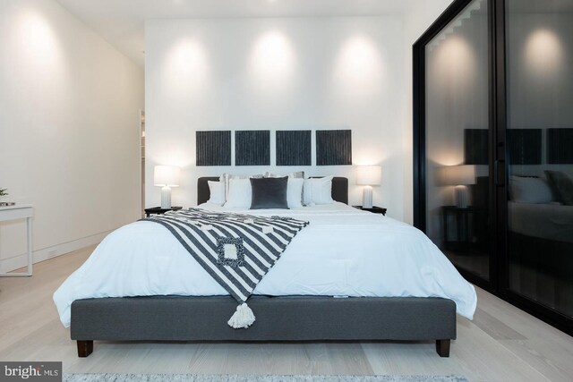 bedroom featuring wood finished floors and recessed lighting