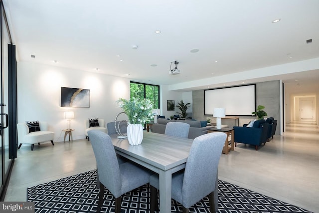 dining area featuring concrete flooring