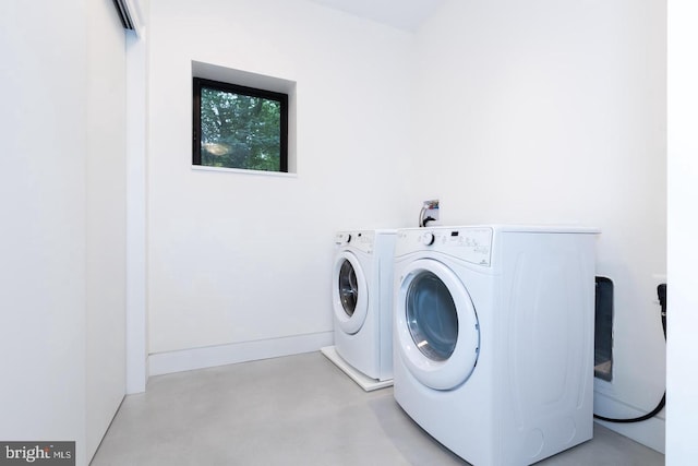 clothes washing area with separate washer and dryer and laundry area