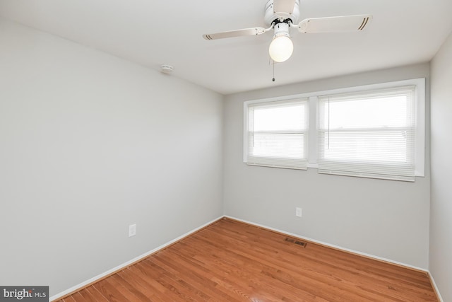 unfurnished room with hardwood / wood-style flooring and ceiling fan