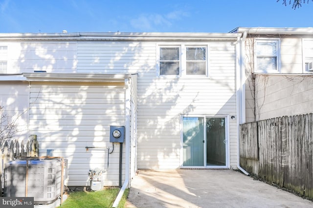 rear view of property featuring central AC and a patio area