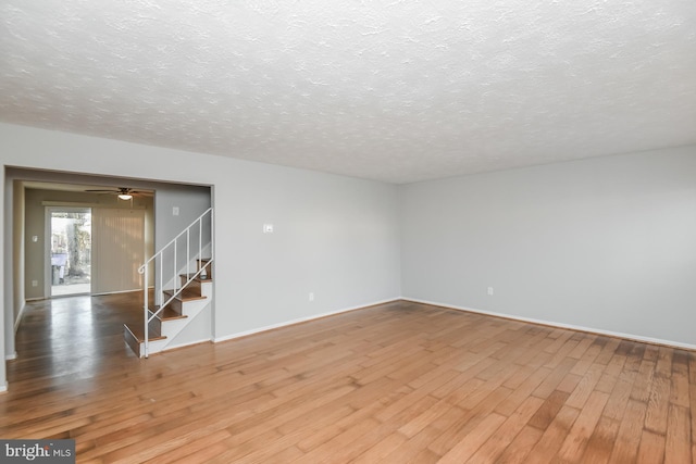 spare room featuring ceiling fan, a textured ceiling, and hardwood / wood-style floors