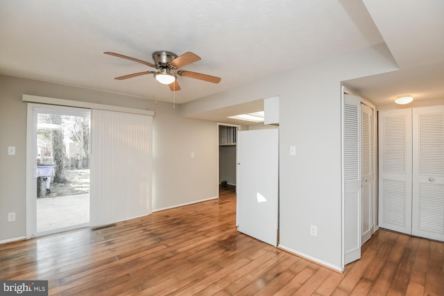 empty room featuring hardwood / wood-style flooring and ceiling fan