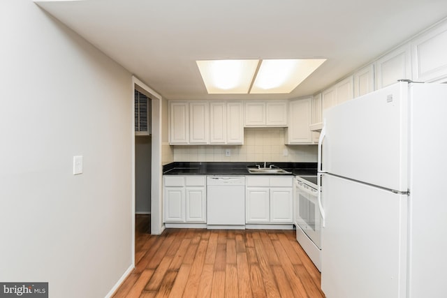 kitchen with white appliances, tasteful backsplash, sink, light hardwood / wood-style floors, and white cabinets