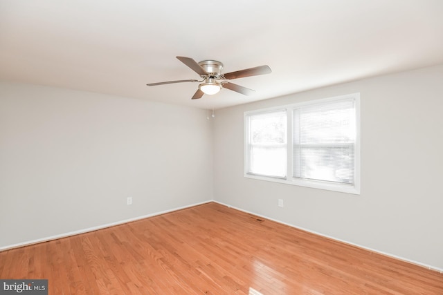 spare room with hardwood / wood-style floors and ceiling fan