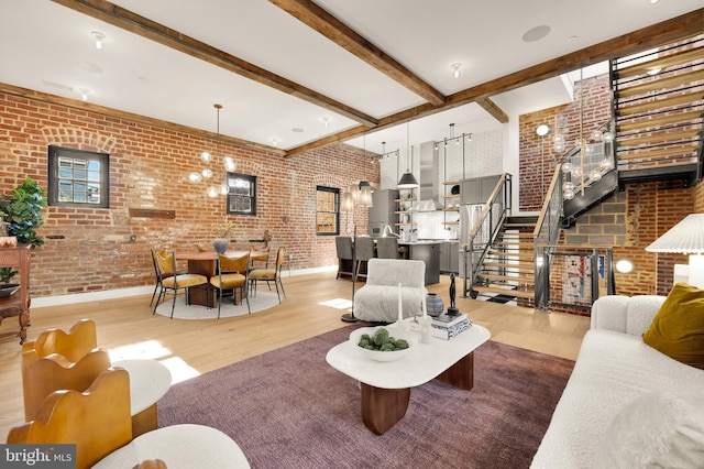 living room featuring hardwood / wood-style flooring, beamed ceiling, and brick wall