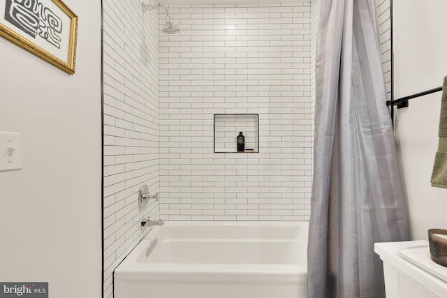 bathroom with shower / bath combo with shower curtain and toilet