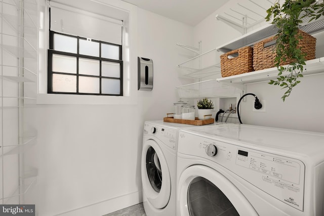 clothes washing area featuring separate washer and dryer