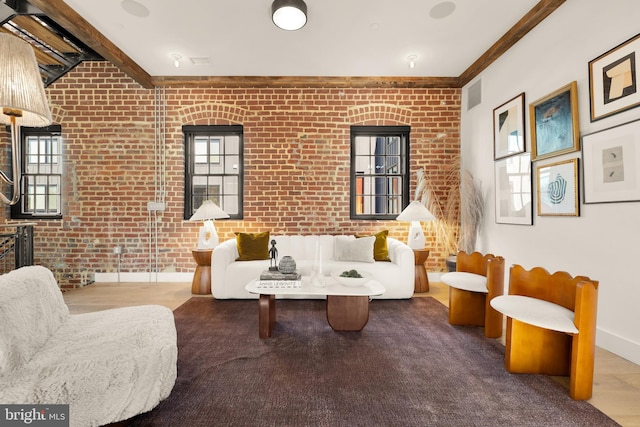 interior space featuring brick wall and beamed ceiling