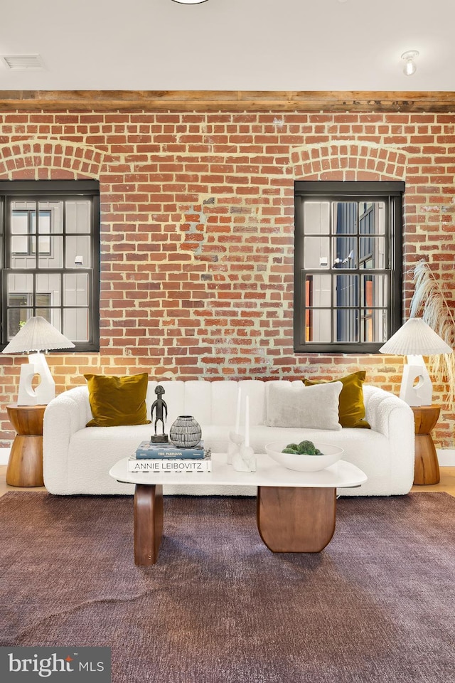 living room with brick wall