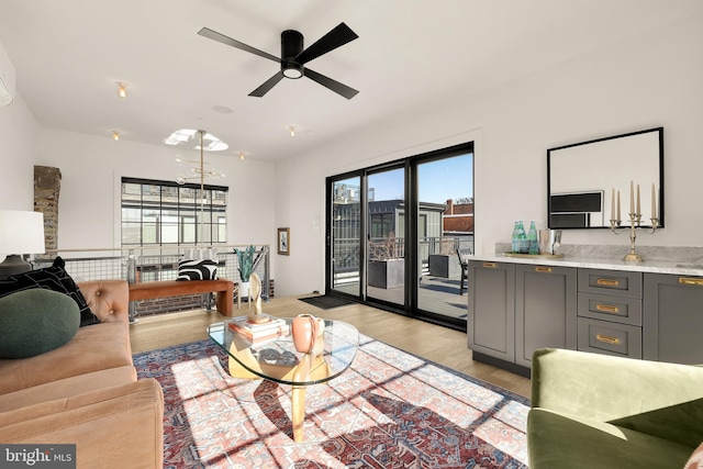 living room with light hardwood / wood-style flooring and ceiling fan