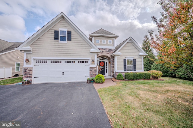 view of front of house featuring a garage and a front lawn