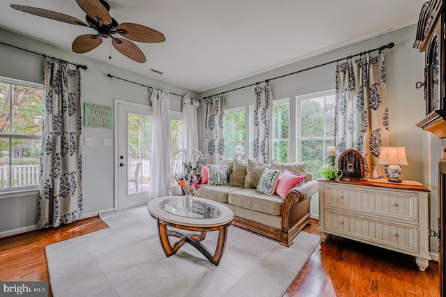 living room featuring wood-type flooring and ceiling fan