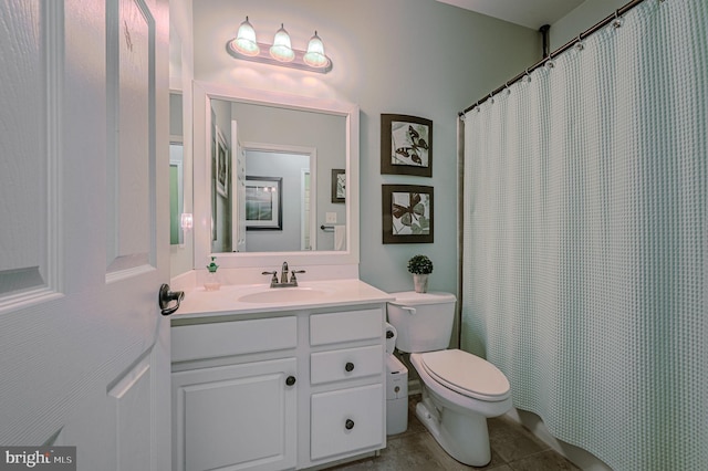 bathroom featuring toilet, vanity, and tile patterned floors