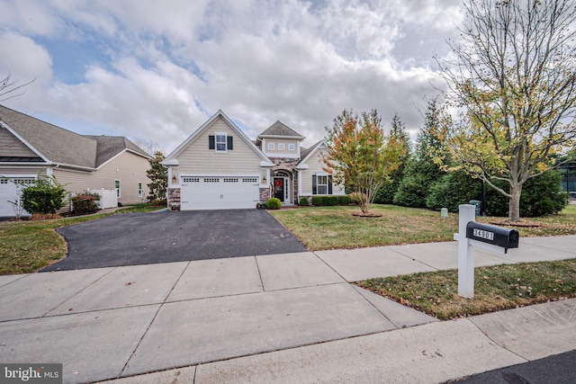 craftsman inspired home with a garage and a front lawn