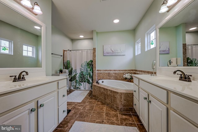 bathroom featuring shower with separate bathtub, vanity, and tile patterned floors