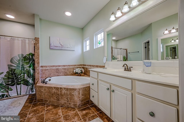 bathroom featuring tile patterned flooring, vanity, and independent shower and bath