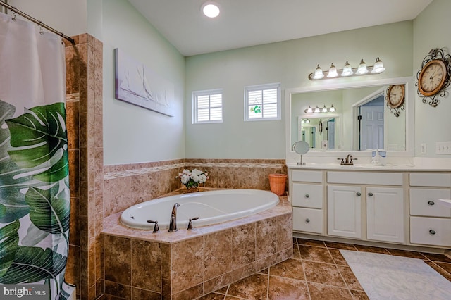 bathroom featuring tile patterned flooring, vanity, and separate shower and tub