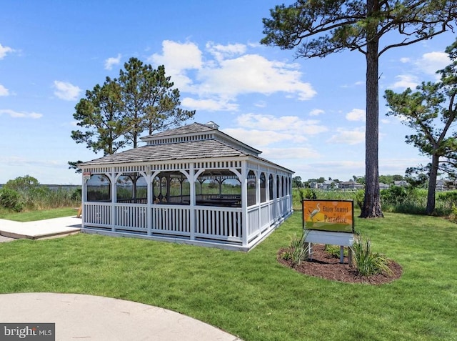 view of property's community with a lawn and a gazebo