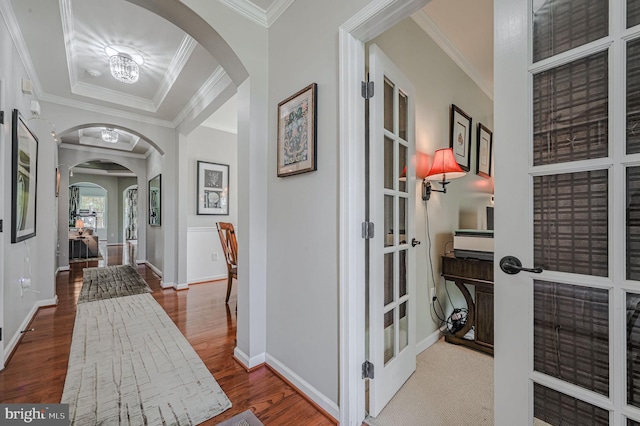 hallway featuring french doors, hardwood / wood-style flooring, and crown molding