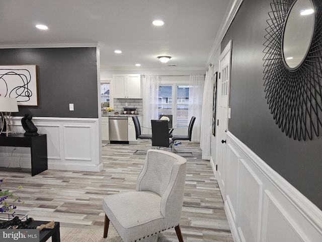 interior space featuring crown molding and light hardwood / wood-style floors