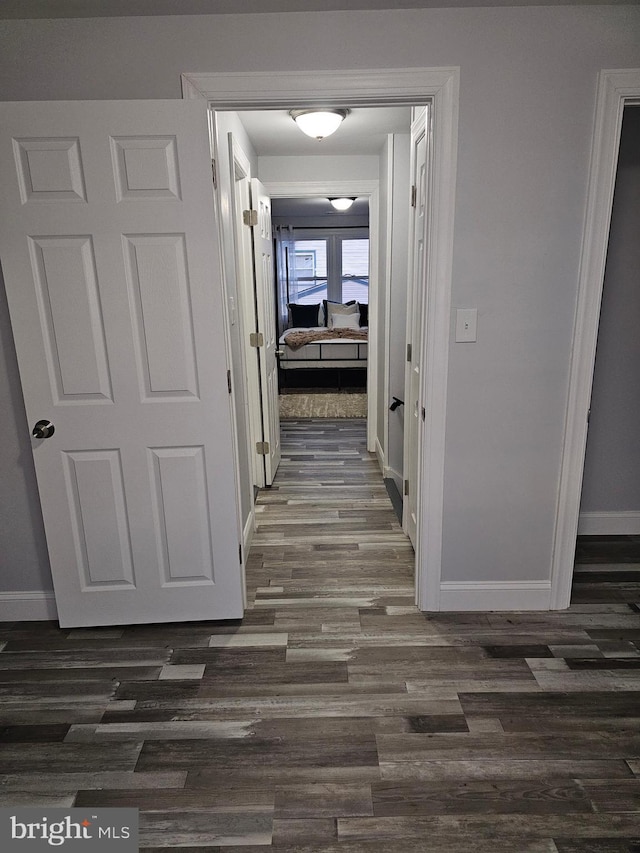 hallway with dark wood-type flooring