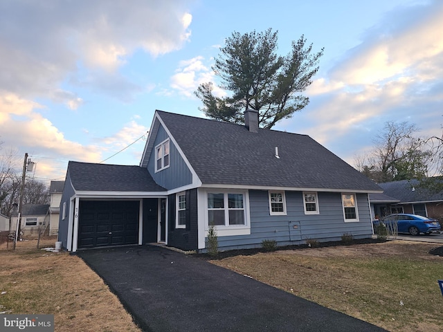 view of front of property featuring a garage and a lawn