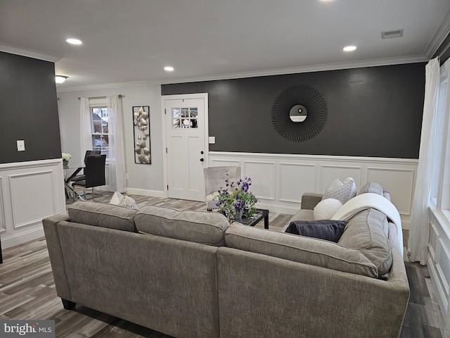 living room featuring hardwood / wood-style flooring and crown molding