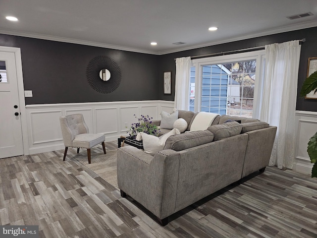 living room featuring crown molding and hardwood / wood-style floors