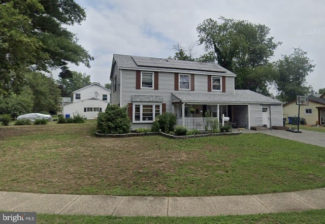 view of front of house with solar panels, a porch, and a front yard