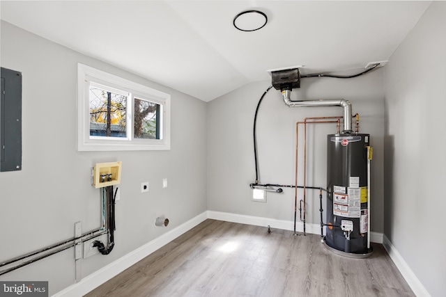 utility room with electric panel and water heater