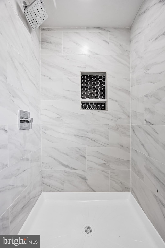 bathroom with tiled shower