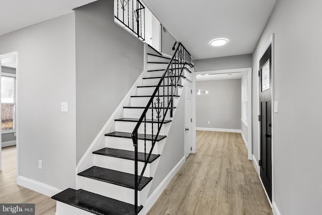 staircase with hardwood / wood-style floors