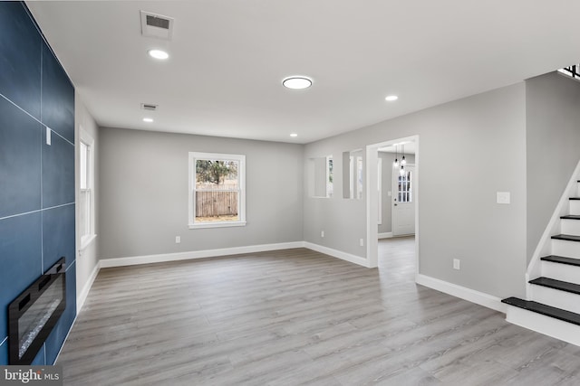 unfurnished living room with light hardwood / wood-style floors