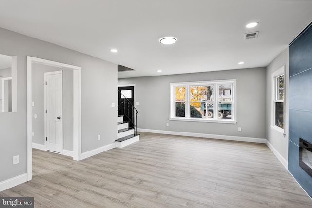 unfurnished living room with light hardwood / wood-style floors