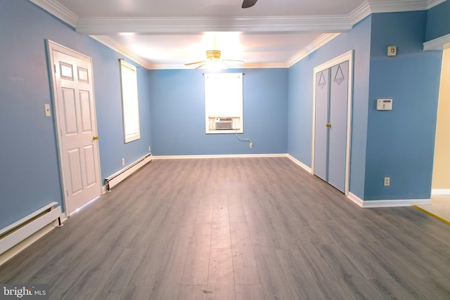 empty room with crown molding, a baseboard heating unit, dark hardwood / wood-style floors, and ceiling fan