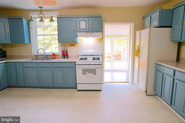 kitchen with a wealth of natural light, backsplash, sink, and white appliances