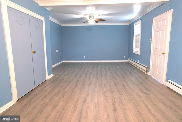 unfurnished bedroom with ornamental molding, hardwood / wood-style floors, and a baseboard radiator