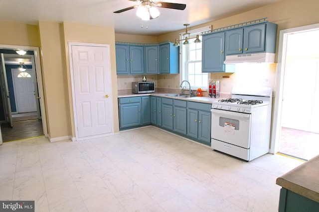 2810 Panther Rd, Vineland, NJ 08361 - kitchen featuring stainless steel microwave, under cabinet range hood, blue cabinets, and white gas stove