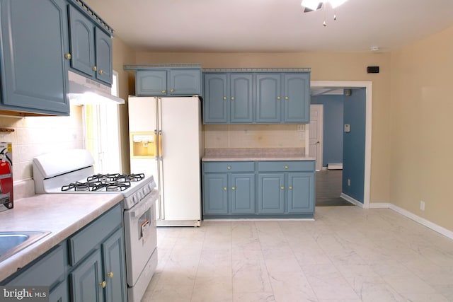 kitchen featuring blue cabinetry, backsplash, and white appliances