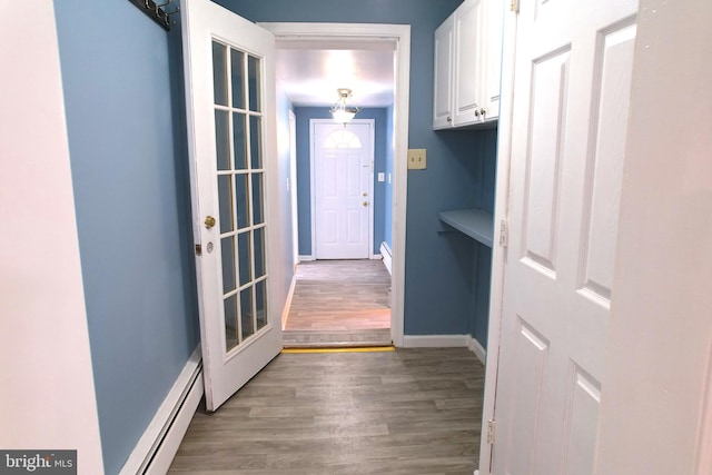 doorway to outside with a baseboard radiator and wood-type flooring