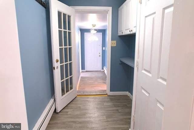 2810 Panther Rd, Vineland, NJ 08361 - hall featuring wood finished floors, baseboards, and a baseboard heating unit